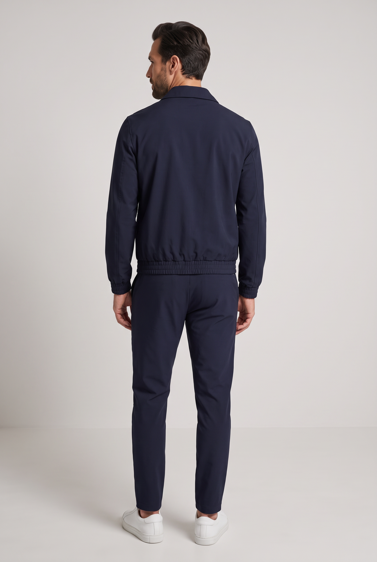 Astos tech suit navy - achterkant