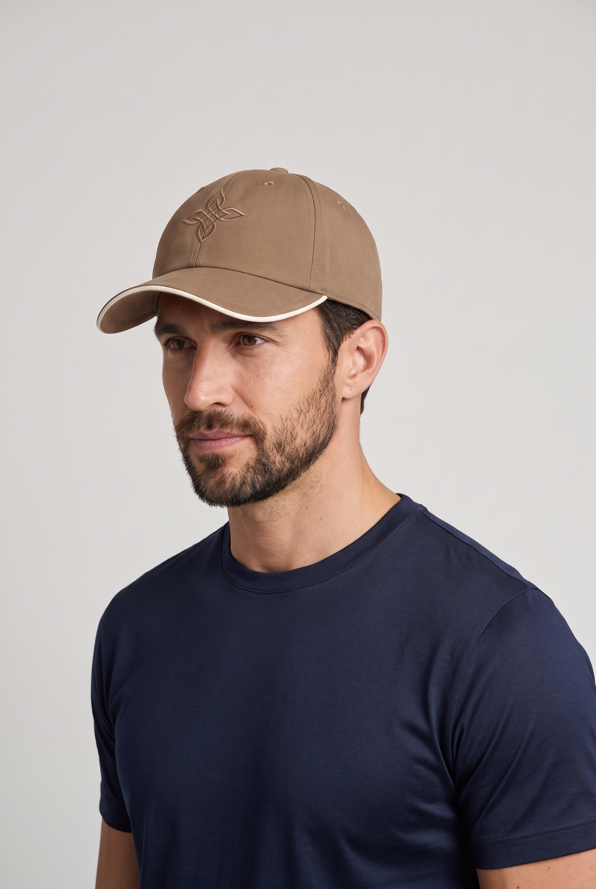 Baseball cap bruin, gedragen door model, vooraanzicht met geborduurd embleem