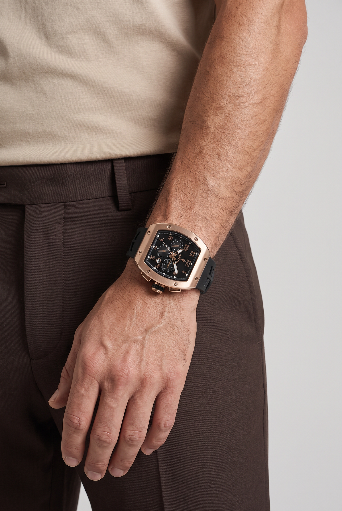 Astos Millionaire 2.0 Rose Gold om de pols, model in zandkleurig shirt, studio